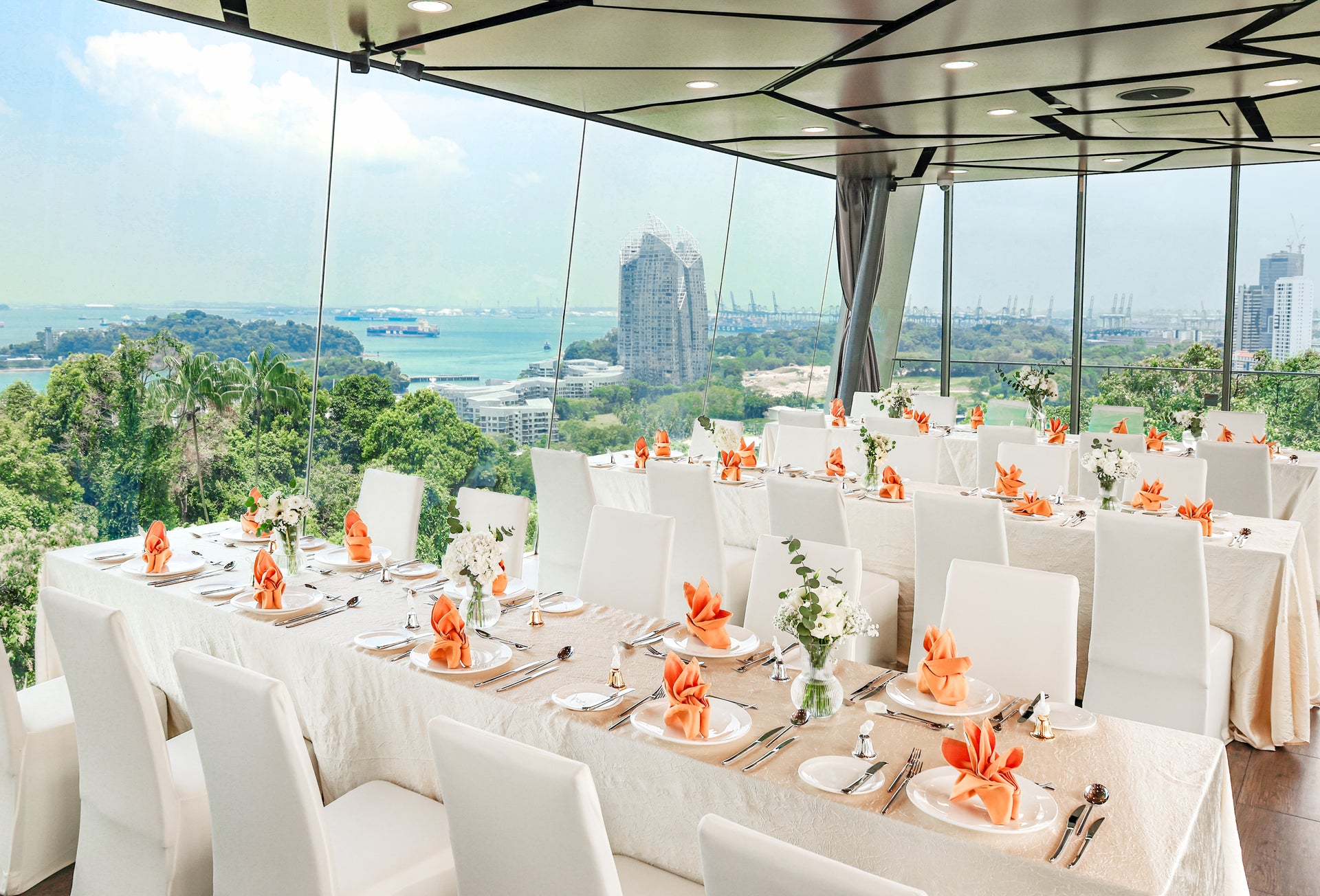 Wedding dining table set up at Angsana Glasshouse with floor to ceiling windows featuring panoramic views of the harbour