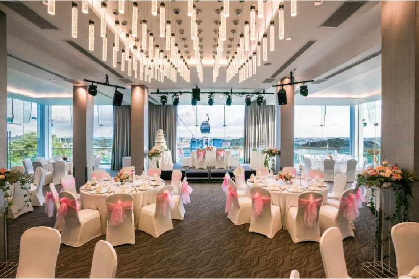 Arbora Ballroom dining set up for wedding with wedding cake onstage and panoramic views of the cable car and the harbour