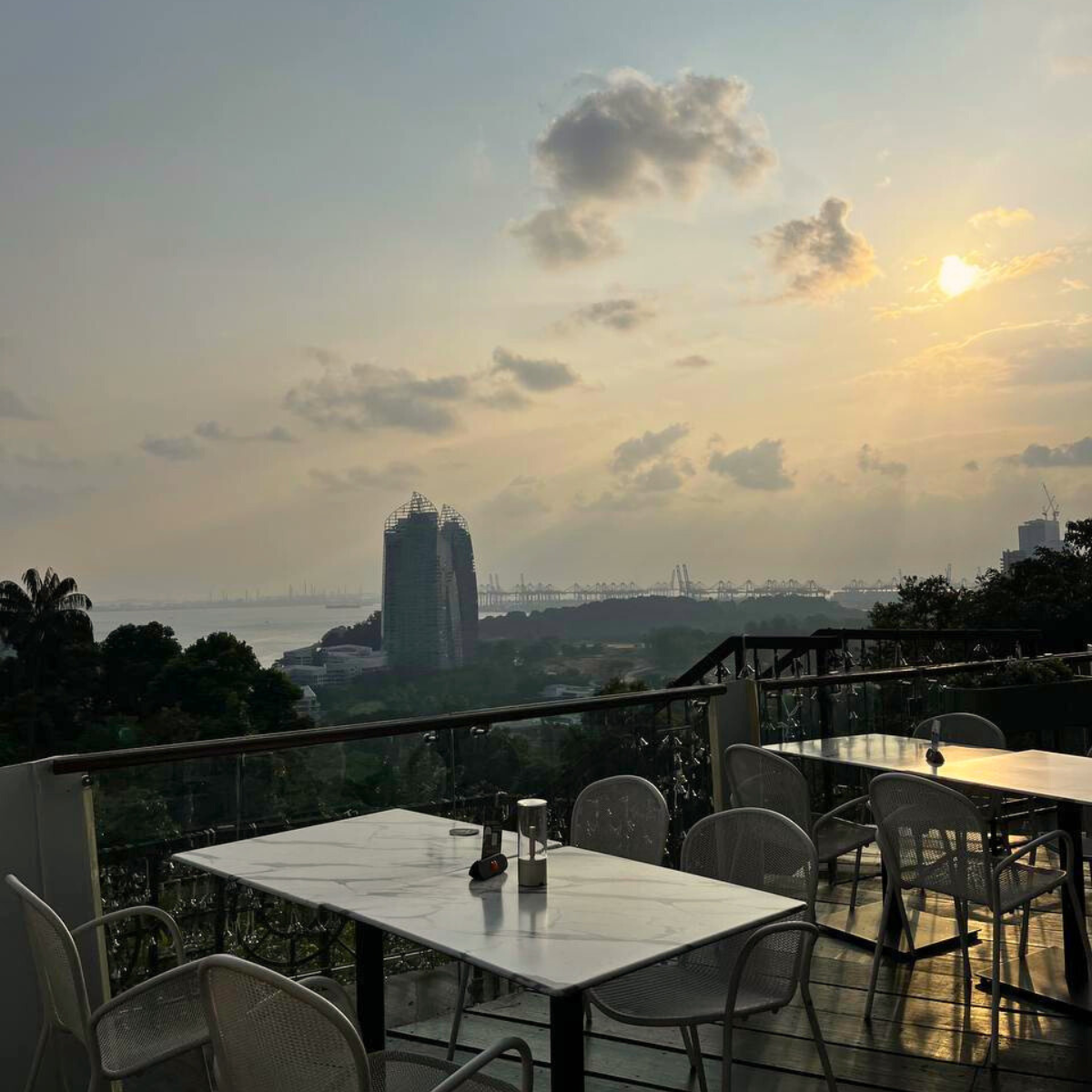 Hilltop view of the sunset and the ocean from Arbora Mount Faber Peak