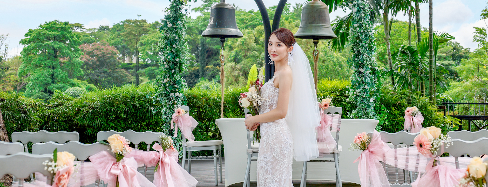 Bride standing holding flowers at Arbora Mount Faber Peak solemnisation ceremony, with Poland's Bells of Happiness